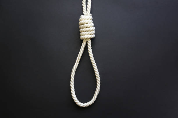 istock Noose lying on black background. Suicide concept. Hanging. Depression disease. 1194932334