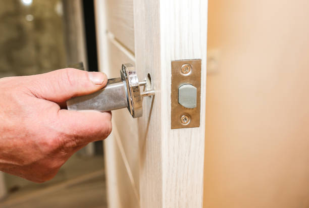 istock Man is installing the doors handle. Repair works. Maintenance in the apartment. 1194932352