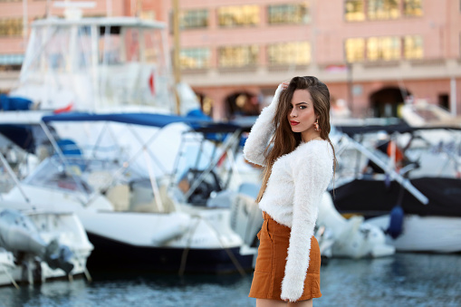 Woman Fashion Model In White Fluffy Knitted Pullover And Brown Miniskirt