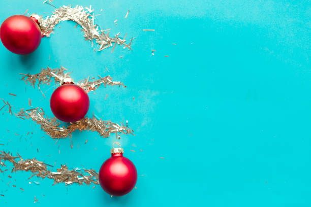 istock Red baubles and silver tinsel stripes on bright blue background. Xmas greeting card 1194934353