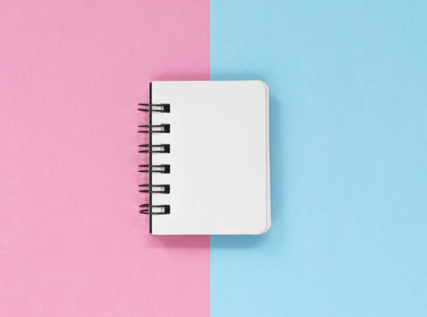 istock Open notebook pages on a pink and blue background 1194935380