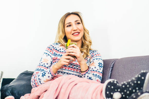 Smiling woman drinking smoothie stock photo