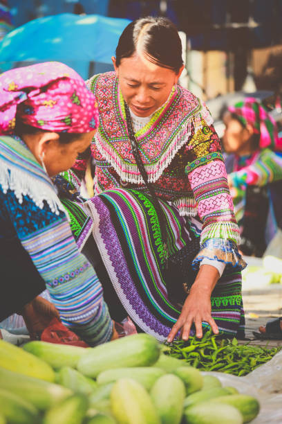 Hmong women selling vetgetable in Bac Ha market, Northern Vietnam. Bac ha, Vietnam - July 7, 2019 : Hmong women selling vetgetable in Bac Ha market, Northern Vietnam. Bac Ha is hilltribe market where people come to trade for goods in traditional costumes bac ha market stock pictures, royalty-free photos & images