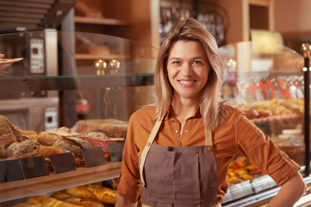 istock Mature female baker working at her store 1194937536