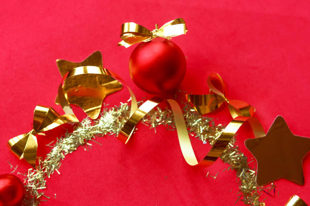 Round Christmas frame with golden decorations on bright red background