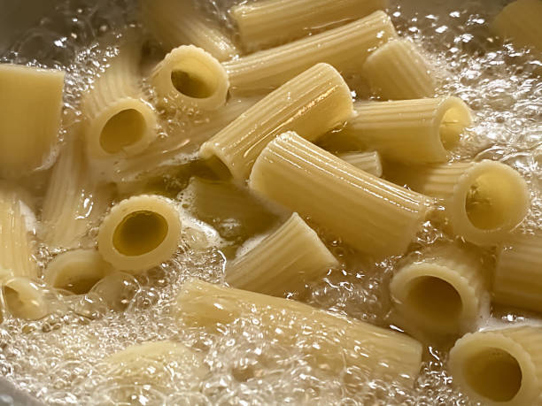 Boiling pasta Close up boiling pasta rigatoni stock pictures, royalty-free photos & images