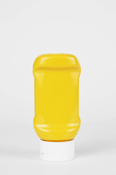 бутылка горчицы на белом фоне - mustard sauce стоковые фото и изображения