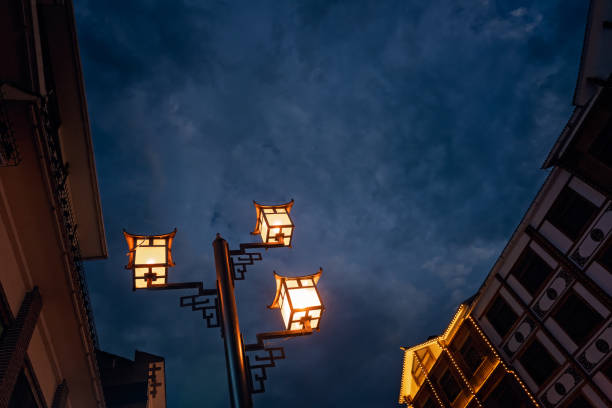 Brightly lit lamppost on the street in Wulingyuan after dusk at night, Hunan Province, China