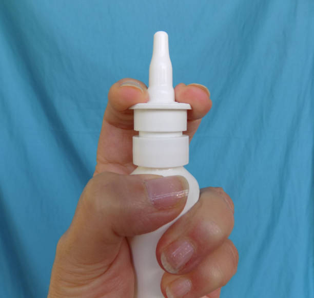 istock Female hand holds a bottle with nose drops 1194946117