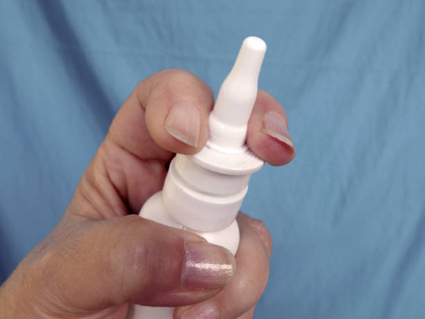 istock Female hand holds a bottle with nose drops 1194946126