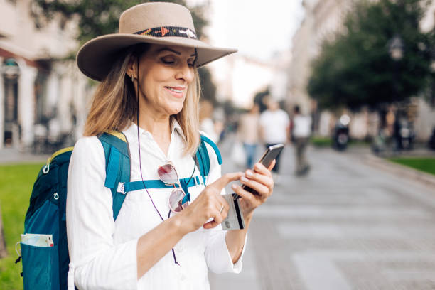 istock Happy woman carrying backpack 1194948141
