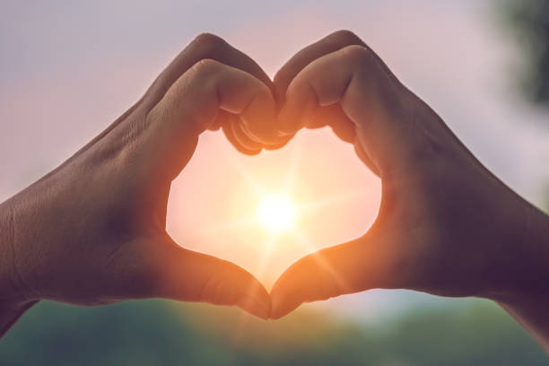 istock Womans hands catching sunlight at dusk 1194950548