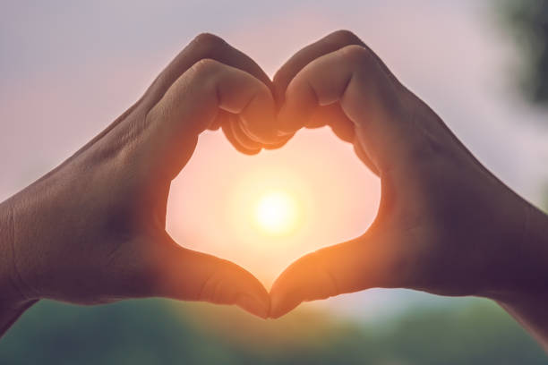 istock Womans hands catching the sun 1194950591