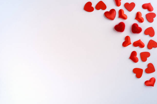 istock Festive composition from red hearts scattered on white background, valentines day concept, copy space 1194953535