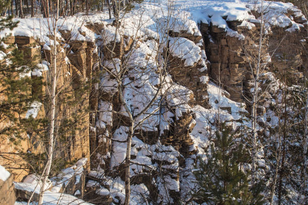 istock landscape with cliffs covered with trees in the snow 1194954399