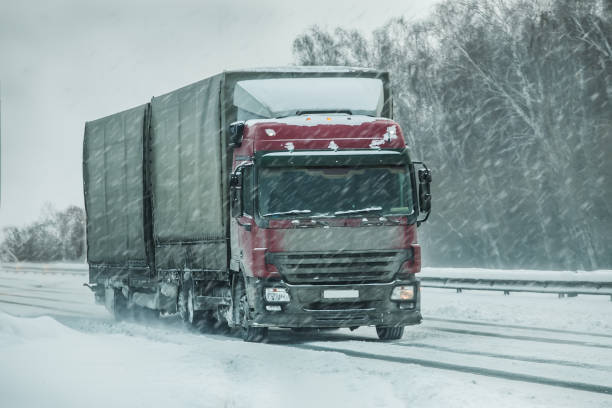 istock truck goes on winter road 1194954488