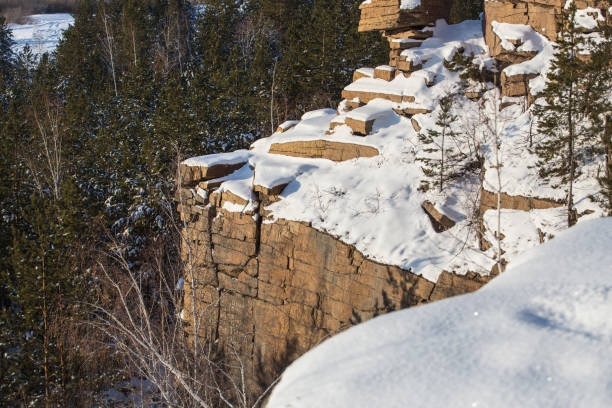 istock landscape with cliffs covered with trees in the snow 1194955047