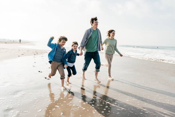 istock Family running on the beach 1194956047