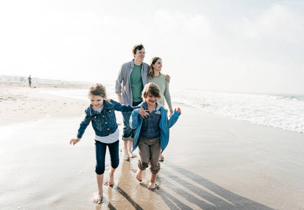 istock Family running on the beach 1194956070