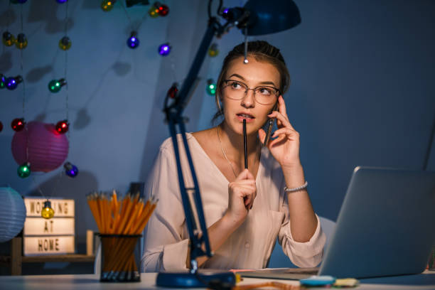 istock Young woman thinking about her business project while on a conference call 1194956222