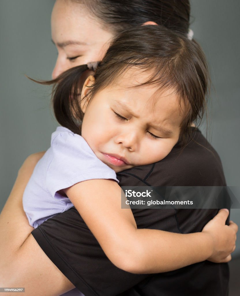 Mother Hugging And Comforting Her Child In Her Arms Parent Love ...