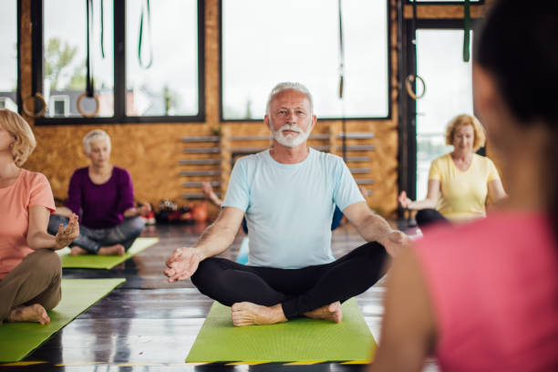 istock Seniors meditating on the yoga class 1194956363