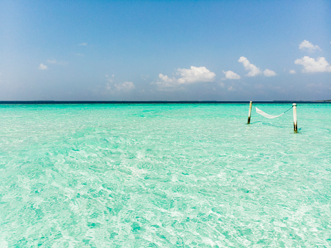 Hammock on amazing white sandbar in pristine tropical waters on a sunny day