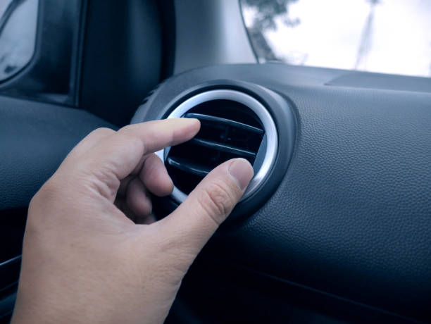 istock Adjusting Air Conditioner in Car 1194961203