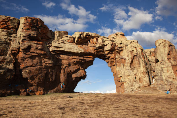 Rock arch in mongolia in cloudy day stock photo