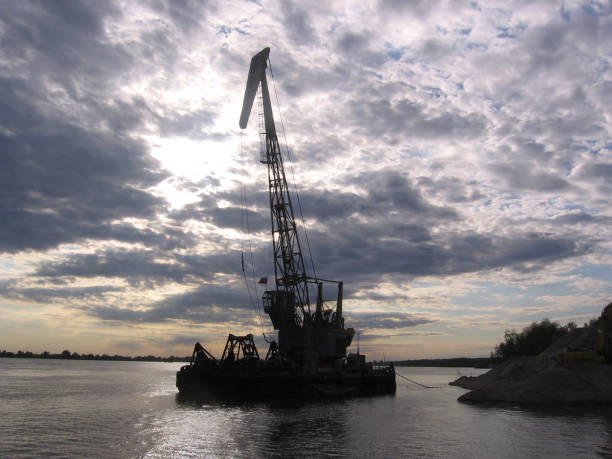 istock high cargo crane on barge in river port mining sand industry 1194969762
