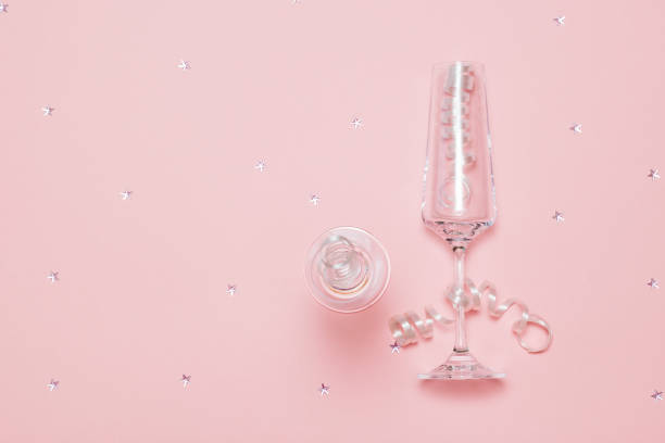 istock Champagne glasses decorated with serpentine on a pink background. 1194971864