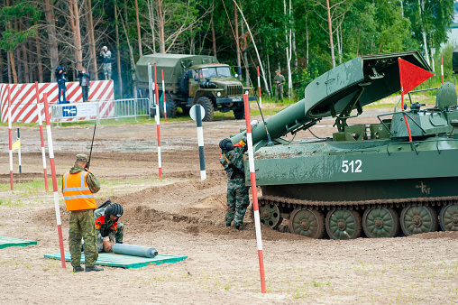 Tyumen, Russia - August 10, 2019: International Army Games. Engineering Formula contest. Highest military and engineering school ground. China crew of Meteorite UR-77 equipment for mine clearing loads shells