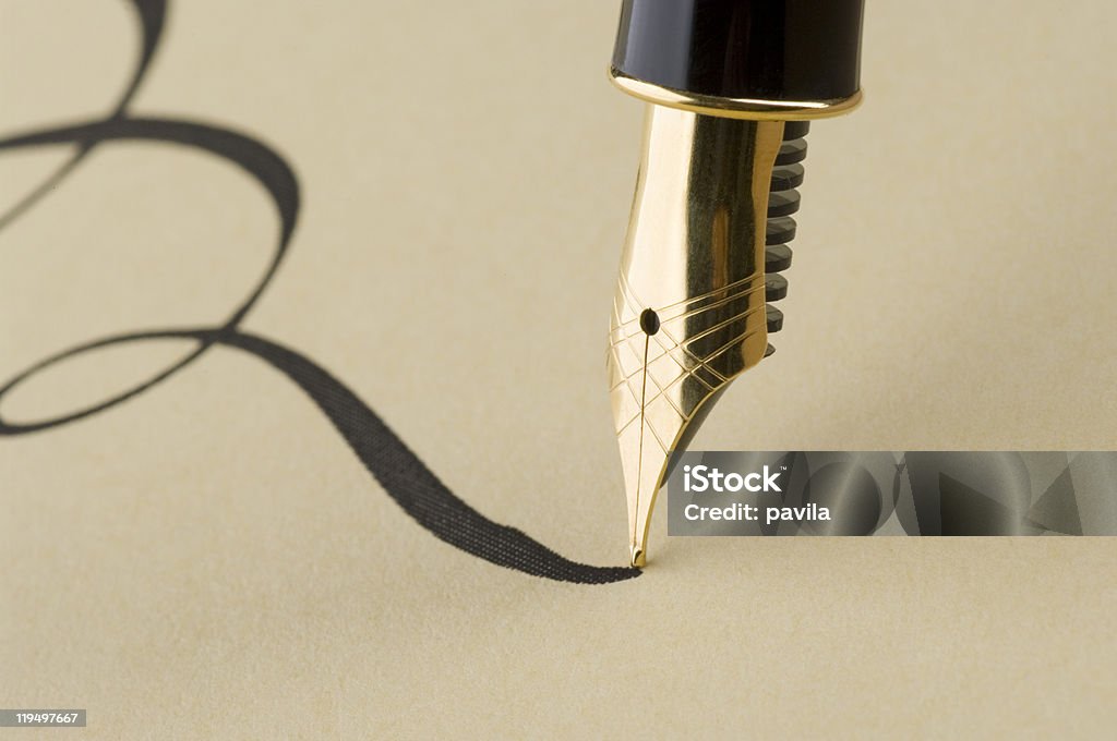 Close up of elegant calligraphy with gold pen  Calligraphy Stock Photo