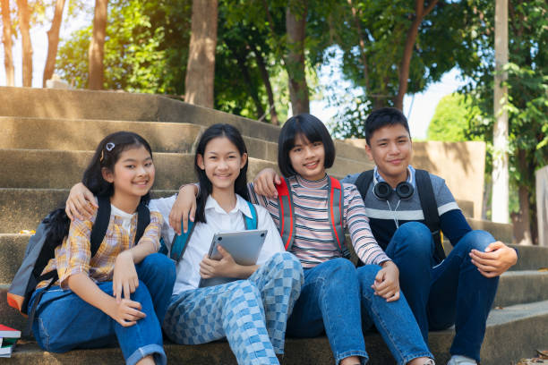 istock Group student young people and education reading book in city park 1194981960