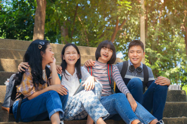 istock Group student young people and education reading book in city park 1194981962