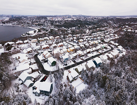 Aerial drone view of fresh snow covering a suburban landscape.