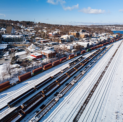 Aerial drone view of a fresh snow on a large railyard.