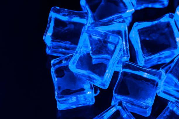 istock Ice cubes on black background with blue backlight. Illuminated ice cubes.  Macro horizontal photography 1194985057
