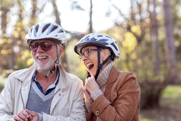 istock Senior couple with bycicles and helmets in park 1194986958