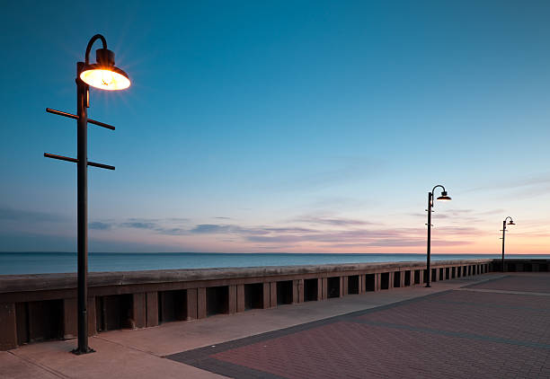 istock Three lamps on wharf at sunrise. 119499084