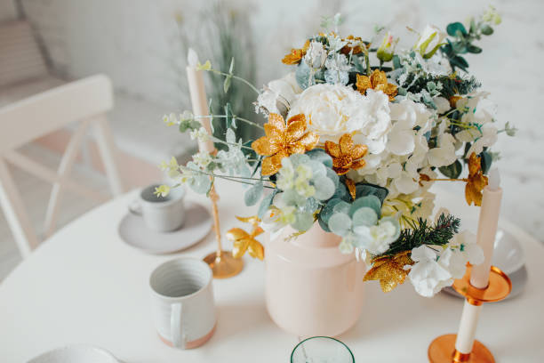 istock White dining room interior design. White round table with flowers, candles and cups. 1194993466