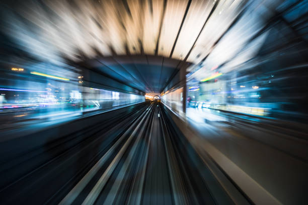 istock Tran running on rails in a night city. 1194996054