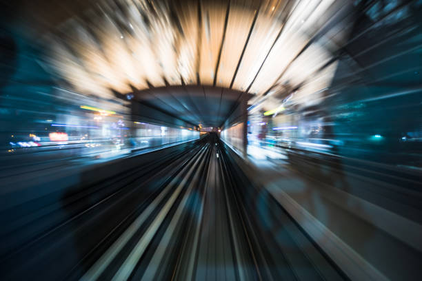 istock Tran running on rails in a night city. 1194996061