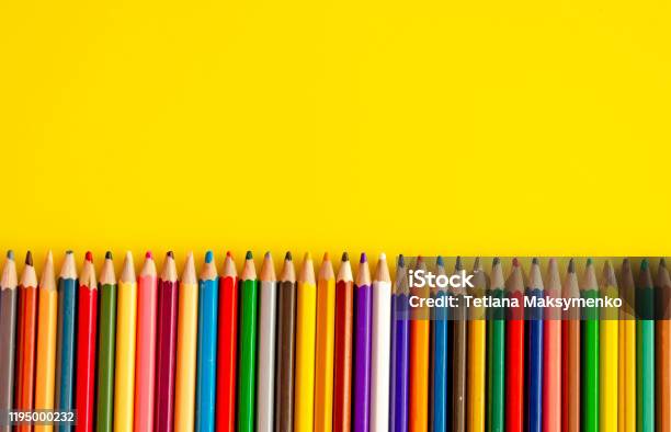 Set Of Colored Pencils Next To Each Other On The Yellow Background Top View Stock Photo - Download Image Now
