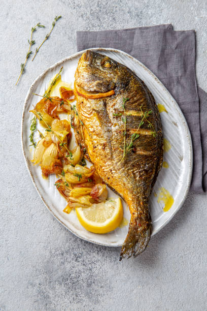 istock Grilled sea bream or dorada on gray plate. Gray background 1195003598