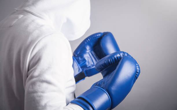 istock Hooded man with a boxing gloves. 1195003691