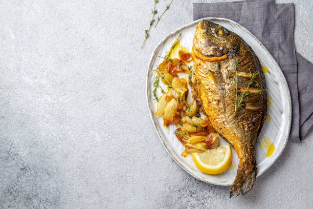 istock Grilled sea bream or dorada on gray plate. Gray background 1195003761