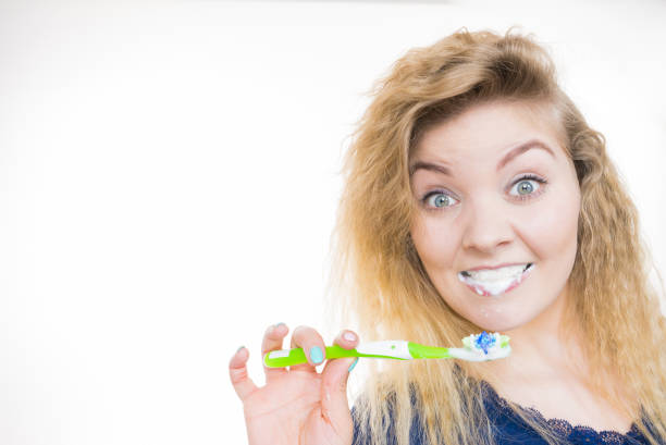 istock Woman brushing cleaning teeth 1195005472