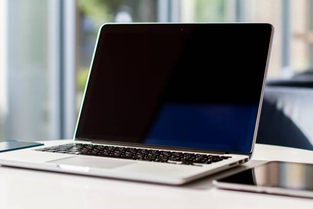 istock Laptop on the table with a digital tablet in sunny interior, mock up 1195006032