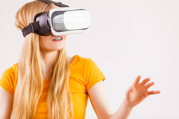 istock Girl wearing virtual reality goggles. 1195006378